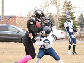 Randy Lizotte, #63, pushes through a defenceman for the Hanna Hawks Football team, who hosted the Brooks St. Josephs Crusaders on Oct. 18. The team, which had almost half it's players heading to Brooks for a Midget game later that day, managed to take an early lead and dominated the field, winning 76-8. Jackie Irwin/Postmedia