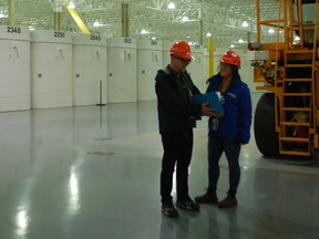 Fred Kuntz, with a co-worker, stands infront of a Gen 4, which is used to line countless numbers of storage bins containing the Nuclear waste that the nwmo hopes to safely dispose of in the coming years. Hannah MacLeod/Kincardine News