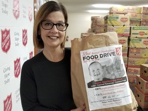 Food bank manager Alice Wannan holds a bag of donated food at the Owen Sound Salvation Army Tuesday in Owen Sound. The annual Thanksgiving food drive starts Friday and runs through Oct. 14.