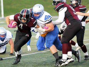 PETER RUICCI
Superior Heights defensive lineman Jakob Hagan (77) wrestles down St. Mary's running back Carter Ianni in 2019 High School Senior Football League action