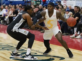 Braylon Rayson, right, of the Sudbury Five, drives to the basket against Marcus Lewis, of the Moncton Magic, during basketball action at the Sudbury Community Arena in Sudbury, Ont. on Thursday March 21, 2019. John Lappa/Sudbury Star/Postmedia Network