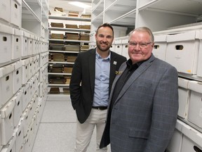 Andrew Meyer, left, general manager of Lambton County's cultural services division, and county Warden Bill Weber are shown in this file photo at county archives. It's one of the county services closed to the public by COVID-19 restrictions.