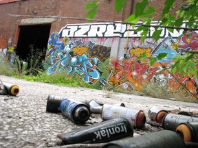 Old spray paint cans are shown scattered outside a building at the former Holmes Foundry site in Point Edward in this file photo from 2012. Point Edward village council has decided tto use its property standards process to push for a cleanup of the site that has sat unused in the years since the foundry closed in the 1980s. File photo/Postmedia Network