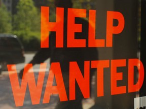 A 'Help Wanted' sign in the window advertises a job opening at a dry cleaners in Boston