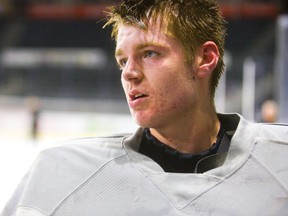 Brett Brochu, the new London Knights' starting goalie, waits on the bench for an equipment repair during practice at Budweiser Gardens. (Mike Hensen/The London Free Press)