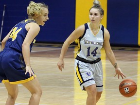 Laurentian Voyageurs guard Kayla Deschatelets, right, handles the ball while being guarded by Windsor Lancers guard Kaylee Anagnostopoulos during OUA women's basketball action at Laurentian University in Sudbury, Ontario on Friday, November 1, 2019.