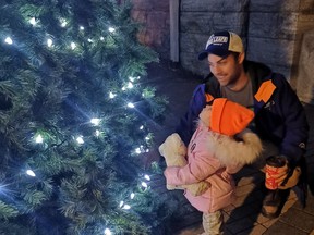 Lily Swift couldn't take her eyes off the bright lights of the Christmas tree outside of the Kincardine Library before the Santa Claus parade in downtown Kincardine on Friday, November 22, with dad Brett. Hannah MacLeod/Kincardine News