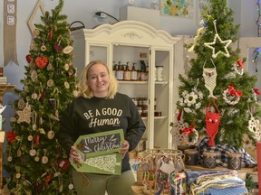 Lindsey Cybulskie, owner of Homegrown House and Patry Inc., poses with her Christmas display at the store on Thursday, Nov. 14.