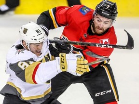 Vegas Golden Knights' Jonathan Marchessault battles against T.J. Brodie of the Calgary Flames during NHL action at the Scotiabank Saddledome in Calgary on Sunday, March 10, 2019. Al Charest/Postmedia