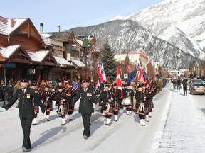 The annual Remembrance Day parade proceeds down Banff Avenue on November 11 as large crowds watched on, showing their respect for members who serve in the Canadian military and British Forces, RCMP, Cadets, Girl Guides and other local authority who figures passed by. Photo Marie Conboy.