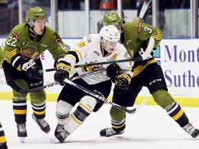 Sarnia Sting's Jamieson Rees (39) squeezes between North Bay Battalion's Harrison Caines (22) and Ryan Thompson (3) in the first period at Progressive Auto Sales Arena in Sarnia, Ont., on Sunday, Nov. 10, 2019. Mark Malone/Chatham Daily News/Postmedia Network