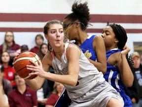 Wallaceburg Tartans' Laura Marcus (5) grabs a rebound away from Kennedy Clippers' Skyla Glover, right, and Aujenaie Crook during the SWOSSAA 'AA' senior girls' basketball final at Wallaceburg District Secondary School in Wallaceburg, Ont., on Wednesday, Nov. 13, 2019. Mark Malone/Chatham Daily News/Postmedia Network