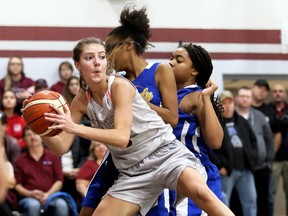 Wallaceburg Tartans' Laura Marcus (5) grabs a rebound away from Kennedy Clippers' Skyla Glover, right, and Awjanae Crook during the SWOSSAA 'AA' senior girls' basketball final at Wallaceburg District Secondary School in Wallaceburg, Ont., on Wednesday, Nov. 13, 2019. Mark Malone/Chatham Daily News/Postmedia Network