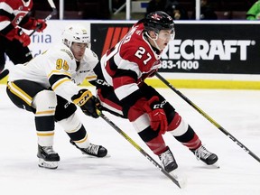 Jack Matier (27) of the Ottawa 67's fends off Sarnia Sting's Justin Nolet (95) in the second period at Progressive Auto Sales Arena in Sarnia, Ont.,  Mark Malone/Chatham Daily News/Postmedia Network