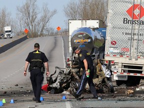 Ontario Provincial Police traffic accident reconstructionists investigate the scene of a multi-vehicle crash that killed four people and injured three others on May 11, 2017, on Highway 401 just west of Joyceville Road. (Ian MacAlpine /The Whig-Standard)