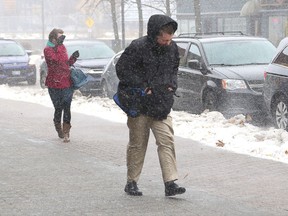 Pedestrians brave the wintery weather while walking on the sidewalk at Durham Street in Sudbury, Ont. on Tuesday November 5, 2019.