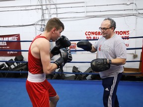 Gord Apolloni, right, of Top Glove Boxing Academy, works with Patrick Martin at the gym in Sudbury, Ont. on Thursday November 28, 2019. John Lappa/Sudbury Star/Postmedia Network
