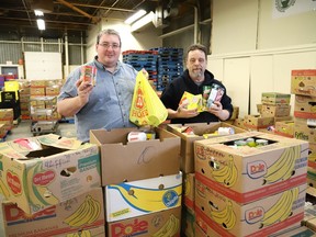 Food co-ordinator Jeff Xilon, left, and warehouse manager Rolly St. George, of the Sudbury Food Bank, sort through donated food items from various schools in Greater Sudbury, Ont. on Tuesday November 26, 2019.