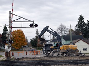 A construction excavator digs up asphalt surrounding the CN rail lines on Wilson Avenue and prepares to place it in a dump truck in Woodstock, Ont. on Monday November 4, 2019. CN crews are working on the rail lines and are expected to finish by the end of the week. (Greg Colgan/Woodstock Sentinel-Review)