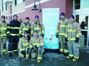 Local firefighters pitched in to help collect donations for the Beaumont-Nisku Christmas Elves last year, stationing themselves outside Sobeys on Nov. 30. (Alex Boates)