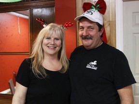 Robby Steed, left, and her husband Jeff, will provide a free Christmas meal Sunday from 1 to 3 p.m. in the lobby at the Voyager Hotel. This is Steed's third year providing the service to those in need.
