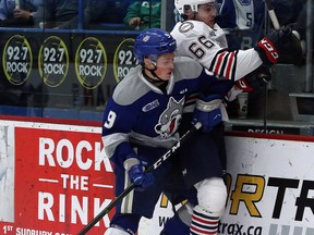 Sudbury Wolves forward Landon McCallum (9) lays a hit on Oshawa Generals defenceman Nico Gross (66) during first-period OHL action at Sudbury Community Arena in Sudbury, Ontario on Friday, October 11, 2019.