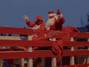 Santa and Mrs. Claus make their annual appearance in the Santa Claus Parade as it marches down Main Street on Saturday, Dec. 7.