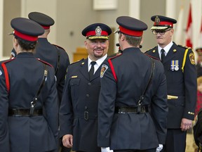 Police chief Robert A. Davis of the Brantford Police Service  inspects the honour guard during a change of command ceremony on  November 29, 2019 in Brantford. At right is retired chief Geoff Nelson. Brian Thompson