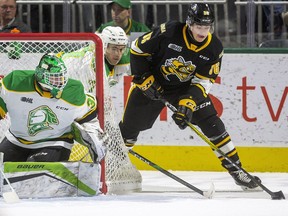 Sarnia Sting's Nolan Burke is trailed by London Knights' Matvey Guskov as he skates behind the net towards goalie Dylan Myskiw in the first period at Budweiser Gardens in London, Ont., on Friday, December 13, 2019.  Mike Hensen/The London Free Press/Postmedia Network