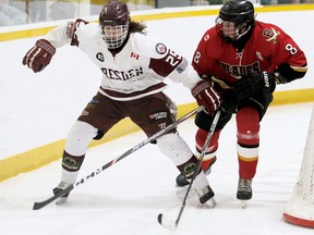 Dresden Kings' Darien Davis (25) and Blenheim Blades' Noah Tetrault (8) chase the puck in the first period at the Ken Houston Memorial Agricultural Centre in Dresden, Ont., on Friday, Dec. 27, 2019. Mark Malone/Chatham Daily News/Postmedia Network