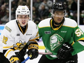 Sarnia Sting's Justin O'Donnell (22) battles London Knights' Bryce Montgomery (58) in the first period at Progressive Auto Sales Arena in Sarnia, Ont., on Sunday, Dec. 29, 2019. Mark Malone/Chatham Daily News/Postmedia Network
