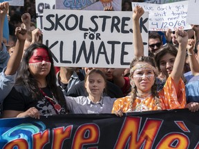 Swedish activist and student Greta Thunberg, centre, takes part in the Climate Strike, in Montreal on Friday, Sept. 27, 2019. THE CANADIAN PRESS/Paul Chiasson