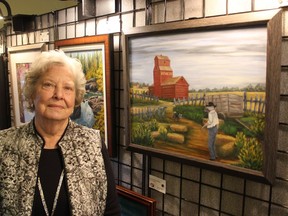 The Foothills Art Club's Beryl Moe with her oil painting 'Remembrance' during the club's spring show at St. Andrew's United Church on April 13. Patrick Gibson/Cochrane Times