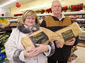 Pastor Wendy Lowden and helper Andy Fitch, of Delhi, shop for items last year for the annual community Christmas banquet at Delhi United Church. Lowden Friday said the church's banquet is a go this year with a curb-side pickup format. -- Monte Sonnenberg
