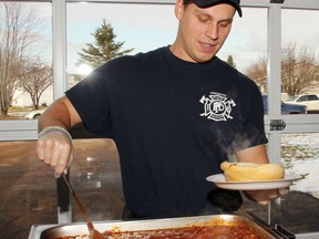 Firefighter Tanner Rutz of the Pembroke Fire Department serves up a bowl of piping hot chili at the Pembroke Professional Firefighters' Association annual Chili Fest fundraiser in 2019.