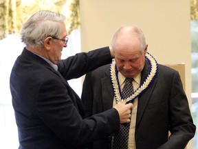 Walter McKenzie places the chain of office on Jim Aitcheson after he was installed as Perth County warden inside the Griffith Auditorium at Spruce Lodge on Thursday December 5, 2019 in Stratford, Ont. (Terry Bridge/Postmedia Network)