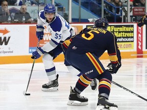 Quinton Byfield, left, of the Sudbury Wolves, attempts to skate around Christopher Cameron, of the Barrie Colts, during OHL action at the Sudbury Community Arena in Sudbury, Ont. on Friday November 29, 2019.