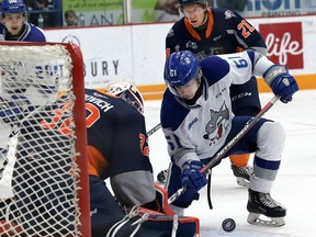Chase Stillman, right, of the Sudbury Wolves, attempts to poke the puck past Anthony Popovich, of the Flint Firebirds, during OHL action at the Sudbury Community Arena in Sudbury, Ont. on Friday December 6, 2019.
