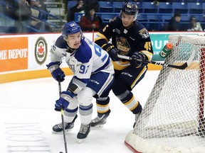 Blake Murray, left, of the Sudbury Wolves, evades Drew Hunter, of the Erie Otters, during OHL action at the Sudbury Community Arena in Sudbury, Ont. on Friday December 13, 2019.