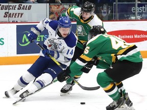 Macauley Carson, left, of the Sudbury Wolves, attempts to elude Gerard Keane, of the London Knights, during OHL action at the Sudbury Community Arena in Sudbury, Ont. on Friday December 20, 2019.