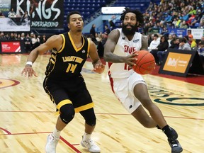 JR Holder, right, of the Sudbury Five, drives to the basket against Mareik Isom, of the London Lightning, during basketball action at the Sudbury Community Arena in Sudbury, Ont. on Monday December 30, 2019. John Lappa/Sudbury Star/Postmedia Network