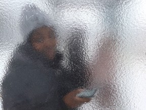 Rashidah Nanyanzi waits for a bus in an ice-covered bus shelter in Sudbury in this file photo.
