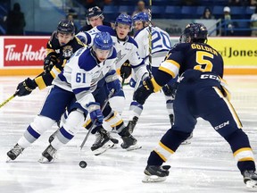 Chase Stillman, left, of the Sudbury Wolves, attempts to skate around Jacob Golden, of the Erie Otters, during OHL action at the Sudbury Community Arena in Sudbury, Ont. on Friday December 13, 2019. John Lappa/Sudbury Star/Postmedia Network