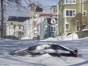 A half buried car is parked in St. John’s on Saturday, January 18, 2020. The state of emergency ordered by the City of St. John's is still in place, leaving businesses closed and vehicles off the roads in the aftermath of the major winter storm that hit the Newfoundland and Labrador capital. THE CANADIAN PRESS/Andrew Vaughan