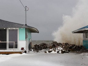 A large wave from Lake Erie comes crashing over a break wall behind a home on Erie Shore Drive near Erieau, Ont. on Saturday January 18, 2020. (Ellwood Shreve/Chatham Daily News)