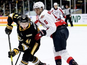 Windsor Spitfires' Dylan Robinson (5) checks Sarnia Sting's Sam Bitten (41) in the first period at Progressive Auto Sales Arena in Sarnia, Ont., on Sunday, Jan. 26, 2020. Mark Malone/Chatham Daily News/Postmedia Network