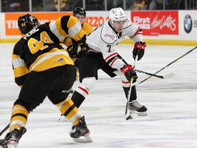 Kingston Frontenacs Lucas Peric keeps an eye on Owen Sound Attack Deni Goure during Ontario Hockey League action at the Leon's Centre in Kingston on Friday January 10, 2020. Ian MacAlpine/Kingston Whig-Standard/Postmedia Network