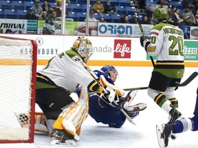 Ethan Larmand of the Sudbury Wolves is upended in front of goalie Joe Vrbetic of the North Bay Battalion, during OHL action at the Sudbury Community Arena in Sudbury, Ont. on Friday. John Lappa/Postmedia Network