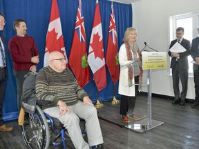 Ken Thomson, in a wheelchair, at the funding announcement for Odawa Heights' latest build, while Ruth Lovell Stanners makes remarks in this Jan. 17, 2020 file photo.