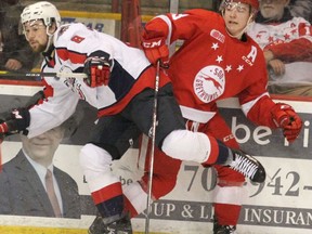 Windsor Spitfires Connor Corcoran and Soo Greyhounds Rory Kerins go into the boards during Ontario Hockey League action at GFL Memorial Gardens. BRIAN KELLY/Sault Star